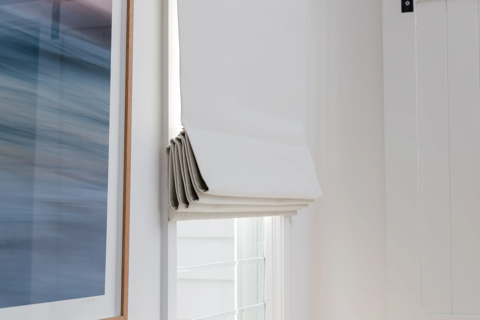 Close up of roman blinds drawn half way